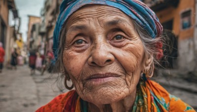 1girl,solo,looking at viewer,hat,jewelry,closed mouth,grey hair,earrings,outdoors,solo focus,day,blurry,black eyes,lips,grey eyes,dutch angle,depth of field,blurry background,building,portrait,blue headwear,realistic,nose,old,old man,old woman,wrinkled skin,1boy,male focus,facial hair,hoop earrings