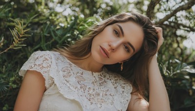 1girl,solo,long hair,looking at viewer,brown hair,shirt,black hair,brown eyes,jewelry,white shirt,upper body,flower,short sleeves,earrings,outdoors,sleeveless,blurry,lips,head tilt,blurry background,plant,hand in own hair,realistic,hand on own head,dress,parted lips,day,artist name,white dress,depth of field,thick eyebrows,nature,lace