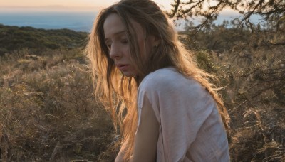 1girl,solo,long hair,breasts,blonde hair,brown hair,shirt,brown eyes,jewelry,closed eyes,white shirt,upper body,short sleeves,earrings,outdoors,parted lips,day,water,from side,tree,lips,scenery,realistic,nose,landscape,closed mouth,sky,blue sky,looking down,nature