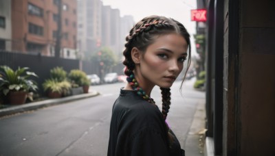 1girl,solo,long hair,looking at viewer,shirt,black hair,brown eyes,jewelry,upper body,braid,multicolored hair,earrings,outdoors,day,blurry,black eyes,twin braids,from side,two-tone hair,dark-skinned female,lips,looking to the side,black shirt,depth of field,blurry background,plant,building,forehead,freckles,city,realistic,nose,potted plant,road,street,dress,closed mouth,dark skin,necklace,black dress,sunlight,sign,alley