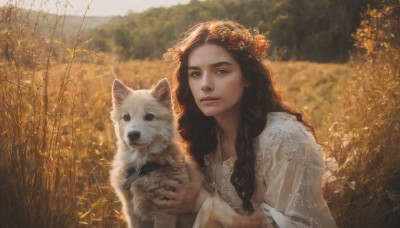 1girl,solo,long hair,looking at viewer,brown hair,black hair,hair ornament,dress,holding,brown eyes,upper body,flower,outdoors,day,hair flower,white dress,blurry,black eyes,collar,tree,lips,see-through,depth of field,blurry background,animal,wavy hair,grass,nature,dog,realistic,nose,head wreath,field,holding animal,long sleeves,parted lips,leaf,sunlight,plant,autumn