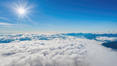 monochrome,outdoors,sky,day,cloud,blue sky,no humans,sunlight,scenery,blue theme,mountain,city,sun,horizon,cityscape,landscape,above clouds,ocean,cloudy sky