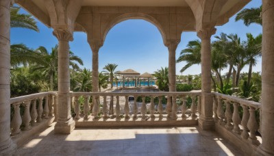 outdoors,sky,day,cloud,tree,blue sky,no humans,shadow,sunlight,plant,building,scenery,stairs,palm tree,railing,shade,pillar,statue,column,water,architecture,bridge,arch