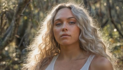 1girl,solo,long hair,looking at viewer,blonde hair,brown eyes,collarbone,upper body,outdoors,parted lips,blurry,tree,lips,depth of field,blurry background,wavy hair,tank top,looking up,portrait,freckles,curly hair,realistic,nose,white tank top,dress,bare shoulders,jewelry,day,necklace,sunlight,thick eyebrows,nature,backlighting,bokeh