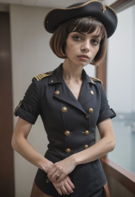 1girl,solo,looking at viewer,short hair,bangs,brown hair,shirt,hat,brown eyes,jewelry,standing,short sleeves,cowboy shot,parted lips,indoors,mole,blurry,uniform,lips,mole under eye,window,black headwear,buttons,blurry background,bob cut,ring,own hands together,freckles,epaulettes,realistic,police,police uniform,policewoman,mole on cheek,jacket,black jacket,wedding ring,pirate hat