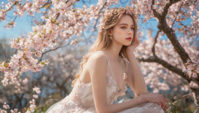 1girl, solo, long hair, breasts, looking at viewer, brown hair, hair ornament, dress, cleavage, brown eyes, jewelry, flower, earrings, outdoors, parted lips, sleeveless, day, hair flower, white dress, blurry, tree, lips, sleeveless dress, depth of field, blurry background, cherry blossoms, head rest, realistic