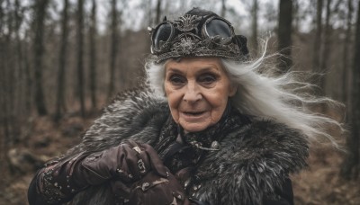 1girl,solo,long hair,looking at viewer,smile,gloves,1boy,hat,jewelry,closed mouth,upper body,white hair,male focus,outdoors,blurry,black eyes,tree,coat,fur trim,floating hair,blurry background,facial hair,scar,ring,goggles,wind,nature,brown gloves,forest,goggles on head,realistic,old,old man,goggles on headwear,old woman,grey hair,helmet,own hands together,crown,wrinkled skin