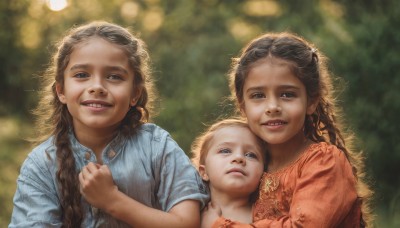 long hair,looking at viewer,smile,open mouth,blue eyes,multiple girls,blonde hair,brown hair,shirt,1boy,dress,2girls,upper body,braid,short sleeves,parted lips,teeth,3girls,blurry,twin braids,lips,hug,depth of field,blurry background,siblings,blue shirt,sisters,child,curly hair,realistic,female child,mother and daughter,family,brown eyes,outdoors,dark skin,grin,dark-skinned female,sunlight,baby