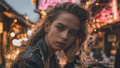 1girl,solo,long hair,looking at viewer,blue eyes,brown hair,jacket,upper body,outdoors,parted lips,dark skin,blurry,dark-skinned female,lips,black jacket,depth of field,blurry background,portrait,freckles,realistic,nose,leather,leather jacket,denim jacket,long sleeves,hand up,from side,night,building,forehead,zipper