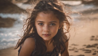 1girl,solo,long hair,looking at viewer,brown hair,bare shoulders,brown eyes,closed mouth,upper body,outdoors,sleeveless,dark skin,water,blurry,dark-skinned female,lips,depth of field,blurry background,ocean,beach,freckles,realistic,nose,sand,dirty,day,floating hair,sunlight,wind,messy hair,portrait,shore