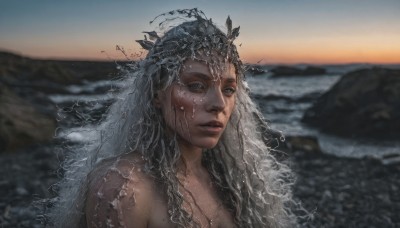 1girl,solo,long hair,looking at viewer,upper body,grey hair,nude,outdoors,parted lips,sky,dark skin,water,mole,blurry,dark-skinned female,lips,wet,grey eyes,depth of field,blurry background,ocean,beach,portrait,freckles,realistic,blue eyes,bare shoulders,closed mouth,crown,veil,sunset,rock