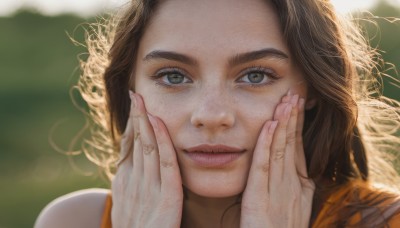 1girl,solo,long hair,looking at viewer,smile,blue eyes,brown hair,brown eyes,blurry,lips,fingernails,grey eyes,eyelashes,depth of field,blurry background,portrait,close-up,curly hair,realistic,nose,hands on own face,hands on own cheeks,closed mouth