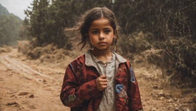 1girl,solo,looking at viewer,short hair,brown hair,shirt,black hair,long sleeves,brown eyes,jewelry,closed mouth,jacket,white shirt,upper body,earrings,outdoors,open clothes,horns,day,blurry,open jacket,tree,lips,depth of field,blurry background,wind,nature,red jacket,realistic,bangs,blue eyes,parted lips,sleeves past wrists,floating hair,messy hair,child,single horn,forest,arm at side,sand,emblem,female child,badge,dirty,dust