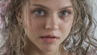 1girl,solo,long hair,looking at viewer,blonde hair,brown hair,brown eyes,parted lips,lips,eyelashes,wavy hair,portrait,close-up,curly hair,realistic,nose,jewelry,green eyes,earrings,grey eyes,messy hair,freckles