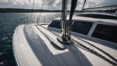 outdoors,sky,day,cloud,water,blue sky,no humans,shadow,ocean,cloudy sky,ground vehicle,building,scenery,motor vehicle,reflection,railing,horizon,car,watercraft,bridge,vehicle focus,boat,ship