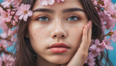 1girl, solo, long hair, looking at viewer, blue eyes, brown hair, hair ornament, flower, parted lips, teeth, hair flower, blurry, lips, cherry blossoms, portrait, close-up, hand on own face, freckles, realistic, nose