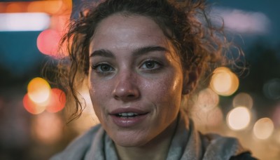 1girl,solo,looking at viewer,smile,short hair,brown hair,black hair,brown eyes,parted lips,teeth,dark skin,grin,blurry,lips,depth of field,blurry background,portrait,freckles,curly hair,realistic,nose,bokeh,night,floating hair,wind