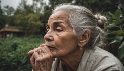 1girl,solo,1boy,jewelry,white hair,grey hair,male focus,earrings,outdoors,day,hand up,hair bun,blurry,from side,tree,depth of field,blurry background,scar,single hair bun,ring,plant,portrait,realistic,nose,wedding ring,old,old man,old woman,wrinkled skin,closed mouth,facial hair,leaf,own hands together,hand on own chin,thinking,praying