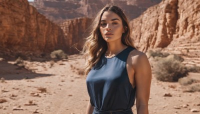 1girl,solo,long hair,breasts,looking at viewer,blue eyes,brown hair,shirt,black hair,bare shoulders,brown eyes,medium breasts,closed mouth,upper body,outdoors,sleeveless,day,belt,blurry,lips,blurry background,tank top,blue shirt,rock,realistic,nose,desert,dress,jewelry,necklace,sunlight,thick eyebrows