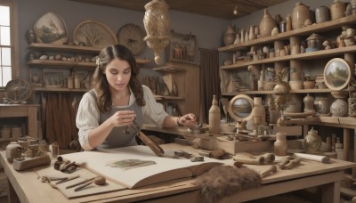 1girl,solo,long hair,brown hair,shirt,black hair,hair ornament,long sleeves,holding,brown eyes,jewelry,sitting,white shirt,flower,indoors,hair flower,cup,lips,book,eyelashes,window,makeup,chair,table,sunlight,bottle,sleeves rolled up,realistic,shelf,jar,needle,quill,cabinet,wooden table,chest of drawers,weighing scale,loaded interior,looking at viewer,braid,day,wavy hair,plant,paper,paintbrush,sleeves pushed up,map,inkwell