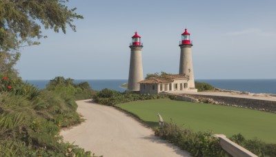 flower,outdoors,sky,day,water,tree,blue sky,no humans,ocean,grass,plant,building,nature,scenery,mountain,road,bush,house,castle,tower,landscape,path,cloud,beach,sand,horizon,shore,lighthouse