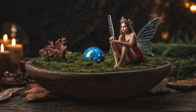 1girl,solo,long hair,breasts,brown hair,hair ornament,dress,cleavage,bare shoulders,brown eyes,medium breasts,sitting,flower,wings,barefoot,pointy ears,blurry,bare legs,strapless,depth of field,red dress,tiara,crown,strapless dress,minigirl,realistic,fairy wings,fairy,mushroom,planet,water,bowl,fantasy,candle,watercraft