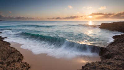 outdoors,sky,day,cloud,water,no humans,ocean,beach,sunlight,cloudy sky,scenery,sunset,rock,sand,sun,horizon,waves,shore,cliff