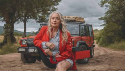 1girl,solo,long hair,looking at viewer,blonde hair,shirt,long sleeves,1boy,holding,brown eyes,sitting,closed mouth,jacket,white shirt,weapon,male focus,outdoors,open clothes,sky,shorts,day,collared shirt,pants,cloud,holding weapon,open jacket,tree,gun,cloudy sky,ground vehicle,holding gun,motor vehicle,red jacket,handgun,realistic,car,grey sky,wavy hair,parody,grass,beard