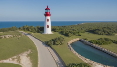 outdoors,sky,day,water,tree,blue sky,no humans,ocean,beach,grass,plant,building,nature,scenery,horizon,road,bush,river,tower,landscape,lake,shore,path,lighthouse,cloud,forest,sand