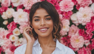 1girl,solo,long hair,looking at viewer,smile,open mouth,brown hair,shirt,brown eyes,collarbone,white shirt,upper body,flower,teeth,collared shirt,hand up,medium hair,grin,blurry,lips,fingernails,depth of field,blurry background,thick eyebrows,portrait,pink flower,realistic,nose,black hair,:d,dark skin,dark-skinned female,floral background