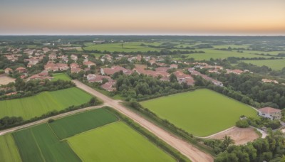 outdoors,sky,day,water,blurry,tree,no humans,ocean,beach,grass,building,nature,scenery,forest,city,horizon,road,cityscape,river,landscape,hill,cloud,sunset,bush,field,house,shore,town