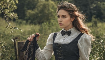 1girl,solo,long hair,blue eyes,brown hair,shirt,long sleeves,dress,bow,holding,white shirt,upper body,flower,outdoors,parted lips,day,bowtie,blurry,vest,tree,lips,black bow,depth of field,blurry background,leaf,plant,nature,black bowtie,realistic,holding clothes,black dress,sunlight,tiara,crown,dappled sunlight