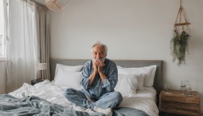 solo,looking at viewer,short hair,blonde hair,shirt,long sleeves,1boy,sitting,male focus,socks,pants,indoors,cup,pillow,window,bed,bed sheet,on bed,bandages,own hands together,blue shirt,plant,curtains,drinking glass,realistic,lamp,bedroom,facial hair,indian style,old,old man