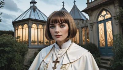 1girl,solo,looking at viewer,smile,short hair,bangs,brown hair,brown eyes,jewelry,closed mouth,upper body,outdoors,sky,day,cloud,blunt bangs,necklace,tree,lips,capelet,bob cut,cloudy sky,cross,plant,building,scenery,stairs,realistic,red lips,bush,cross necklace,white capelet,latin cross,church,priest,blue eyes,artist name,blue sky,window,nose,architecture