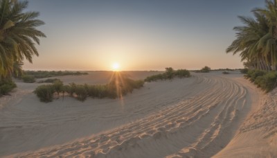 outdoors,sky,day,cloud,water,tree,no humans,ocean,beach,sunlight,nature,scenery,sunset,mountain,sand,palm tree,sun,horizon,shore,sunrise,desert