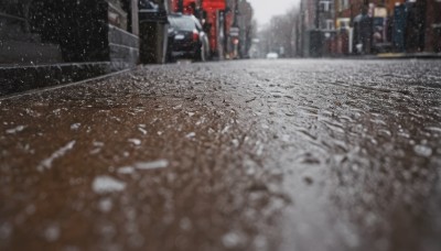 outdoors,blurry,no humans,depth of field,ground vehicle,building,scenery,motor vehicle,snow,snowing,city,sign,realistic,car,road,winter,lamppost,street,photo background,real world location,coat,blurry background,fence,sidewalk