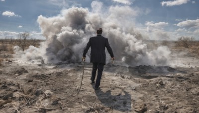 solo,short hair,black hair,long sleeves,1boy,holding,standing,jacket,male focus,outdoors,sky,day,pants,cloud,from behind,tree,blue sky,black jacket,black pants,formal,cloudy sky,suit,scenery,smoke,walking,ruins,black suit,rubble,grass,rope,rock,realistic,sand