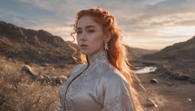 1girl,solo,long hair,breasts,looking at viewer,blue eyes,brown hair,dress,jewelry,closed mouth,upper body,red hair,earrings,outdoors,sky,day,artist name,cloud,signature,white dress,orange hair,blurry,lips,eyelashes,blurry background,wavy hair,freckles,curly hair,mountain,realistic,nose,field,mountainous horizon,medium breasts,parted lips,sunlight,thick eyebrows,cloudy sky,wind,backlighting,mole on cheek