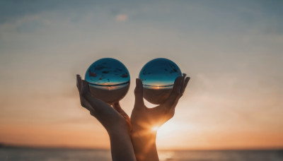 holding, outdoors, sky, cloud, blurry, scenery, 1other, sunset, sun, desert