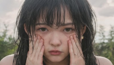 1girl,solo,long hair,looking at viewer,bangs,black hair,bare shoulders,brown eyes,jewelry,closed mouth,earrings,outdoors,day,blurry,lips,depth of field,blurry background,ring,portrait,close-up,freckles,realistic,nose,hands on own face,straight-on,hands on own cheeks,hands up,messy hair