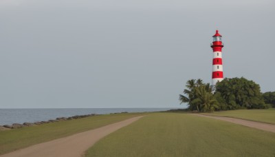 outdoors,sky,day,cloud,water,tree,blue sky,no humans,ocean,beach,grass,building,scenery,horizon,road,bush,tower,path,grey background,nature,forest,palm tree,traffic cone,lighthouse