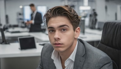 solo,looking at viewer,short hair,brown hair,shirt,1boy,brown eyes,sitting,closed mouth,jacket,white shirt,upper body,male focus,multiple boys,solo focus,collared shirt,indoors,blurry,lips,grey eyes,blurry background,chair,formal,suit,realistic,grey jacket,computer,monitor,photo background,real life insert,office,black jacket,dress shirt,depth of field,facial hair,expressionless,3boys,portrait,stubble