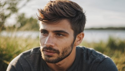 solo,short hair,brown hair,shirt,black hair,1boy,closed mouth,upper body,male focus,outdoors,day,blurry,black eyes,looking to the side,blurry background,facial hair,thick eyebrows,portrait,beard,realistic,mustache,smile,brown eyes,lips,depth of field,nose