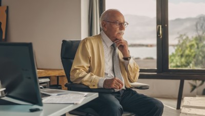 solo,shirt,long sleeves,1boy,sitting,jacket,white shirt,male focus,necktie,glasses,collared shirt,pants,indoors,blurry,open jacket,window,blurry background,facial hair,chair,black pants,formal,suit,black necktie,beard,watch,realistic,round eyewear,wristwatch,computer,bald,hand on own chin,old,monitor,on chair,old man,fat man,photo background,keyboard (computer),thinking,closed mouth,white hair,grey hair,open clothes,tree,dress shirt,depth of field,table,plant,black-framed eyewear,brown jacket,laptop,mouse (computer),office,wrinkled skin