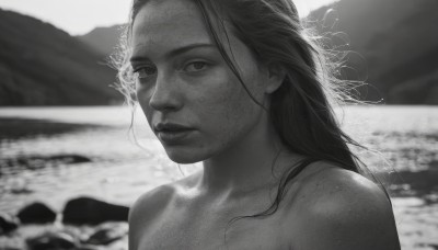 1girl,solo,long hair,looking at viewer,closed mouth,monochrome,upper body,greyscale,nude,outdoors,parted lips,water,blurry,lips,depth of field,blurry background,ocean,beach,messy hair,portrait,freckles,realistic,nose,bare shoulders,collarbone,expressionless,sunlight