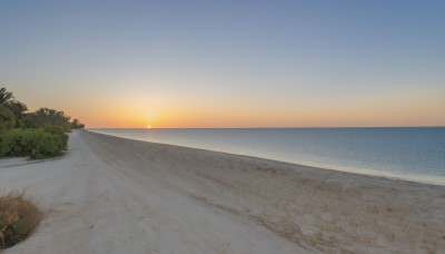 outdoors,sky,day,water,tree,blue sky,no humans,ocean,beach,grass,plant,scenery,sunset,sand,sun,horizon,gradient sky,shore,sunrise,desert,cloud,bush,orange sky