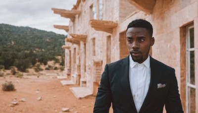 solo,short hair,shirt,black hair,1boy,jacket,white shirt,upper body,male focus,outdoors,parted lips,day,collared shirt,dark skin,blurry,black eyes,black jacket,looking to the side,dress shirt,blurry background,facial hair,parody,formal,dark-skinned male,suit,building,beard,realistic,very dark skin,photo background,real life insert,looking at viewer,smile,long sleeves,brown eyes,closed mouth,very short hair