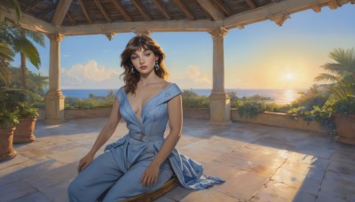 1girl,solo,long hair,breasts,looking at viewer,bangs,blue eyes,brown hair,dress,cleavage,bare shoulders,jewelry,medium breasts,sitting,collarbone,earrings,outdoors,parted lips,sky,sleeveless,day,belt,cloud,indoors,off shoulder,tree,blue sky,lips,no bra,makeup,blue dress,shadow,sunlight,plant,lipstick,breasts apart,palm tree,sun,red lips,potted plant,pillar,column,scenery,sunset,realistic