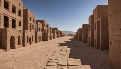 outdoors,sky,day,blue sky,no humans,shadow,building,scenery,sand,road,ruins,desert,window,wall,pillar,arch