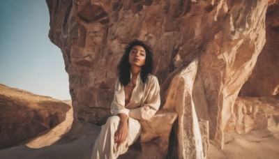 1girl,solo,long hair,breasts,looking at viewer,shirt,black hair,long sleeves,1boy,sitting,male focus,outdoors,open clothes,pants,dark skin,black eyes,dark-skinned female,lips,open shirt,crossed legs,robe,rock,realistic,white robe,desert,sky,day